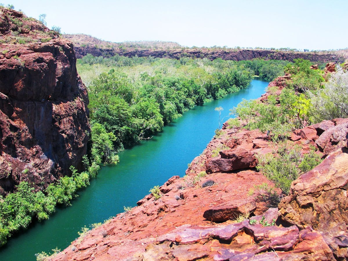 View down into gorge, blue river surrounded by steep rocky cliffs