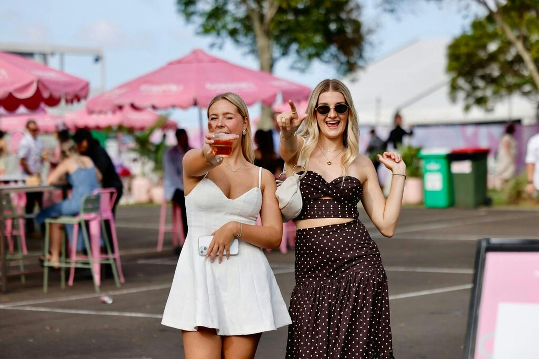 Groups of friends socialising and enjoying the atmosphere at a spring racing event.