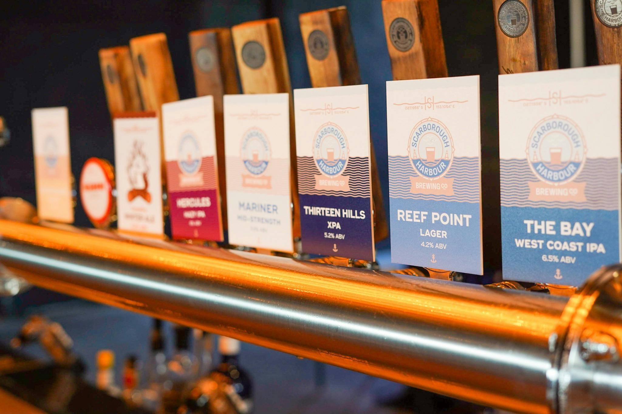 Showing tap decals and timber tap handles with stainless steel at the bar