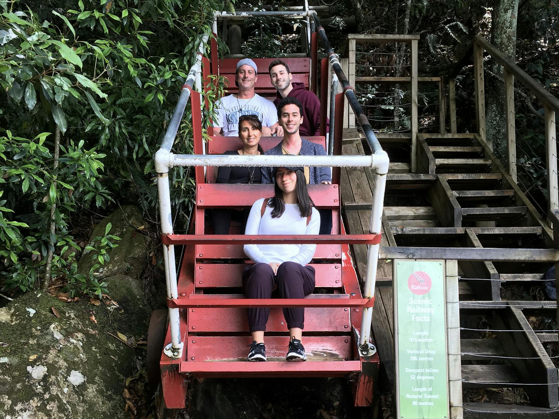 Family sitting in one of the old carriages of the Scenic Railway at Scenic World
