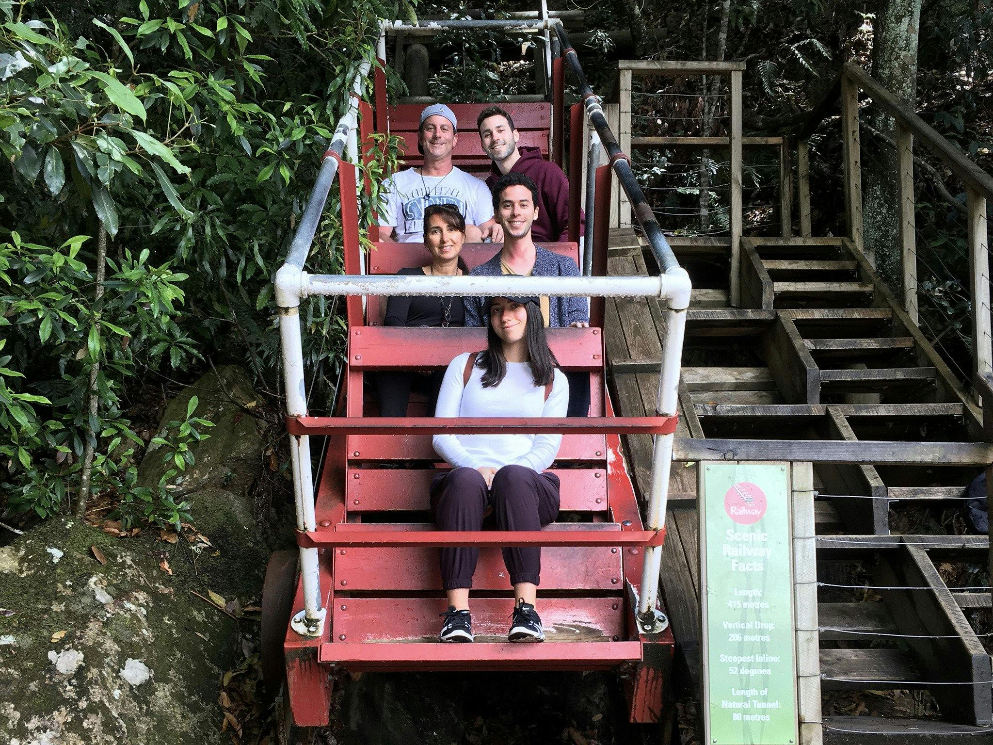 Family  sitting in one of the old carriages of the Scenic Railway at Scenic World