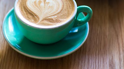 Cup of coffee with a love heart on top