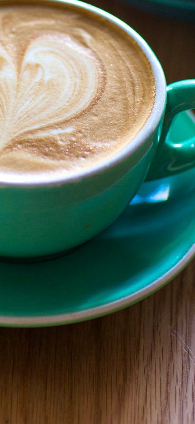 Cup of coffee with a love heart on top