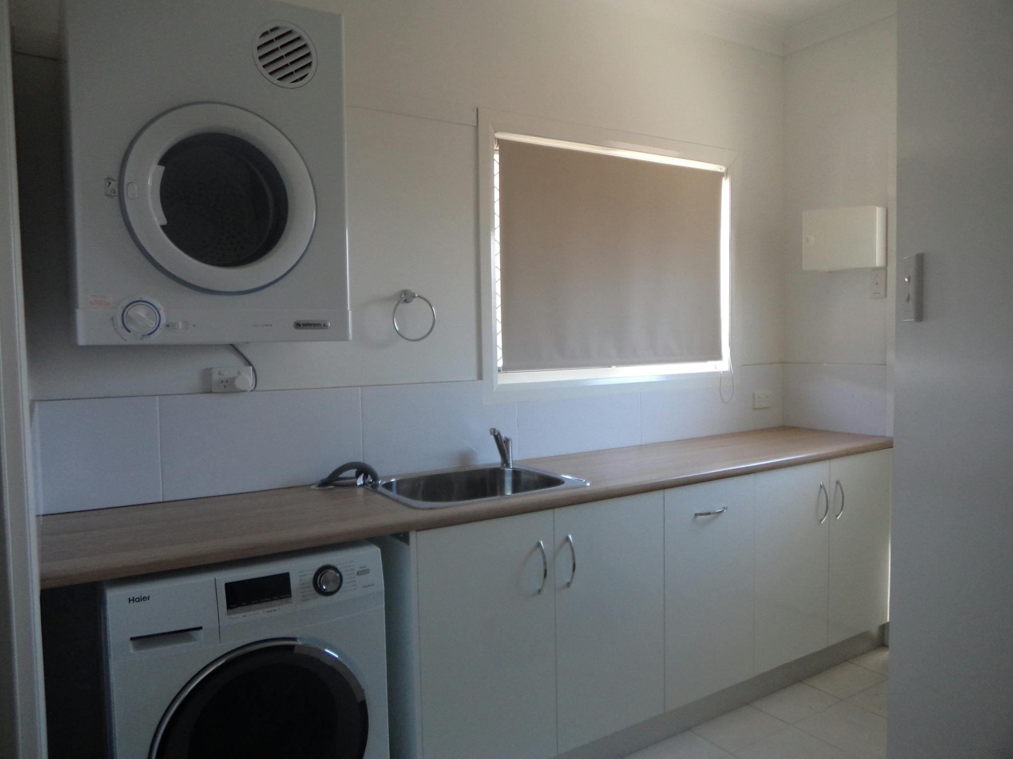 Functional laundry with   wall mounted Drier ,  and underbench front load washing machine ,