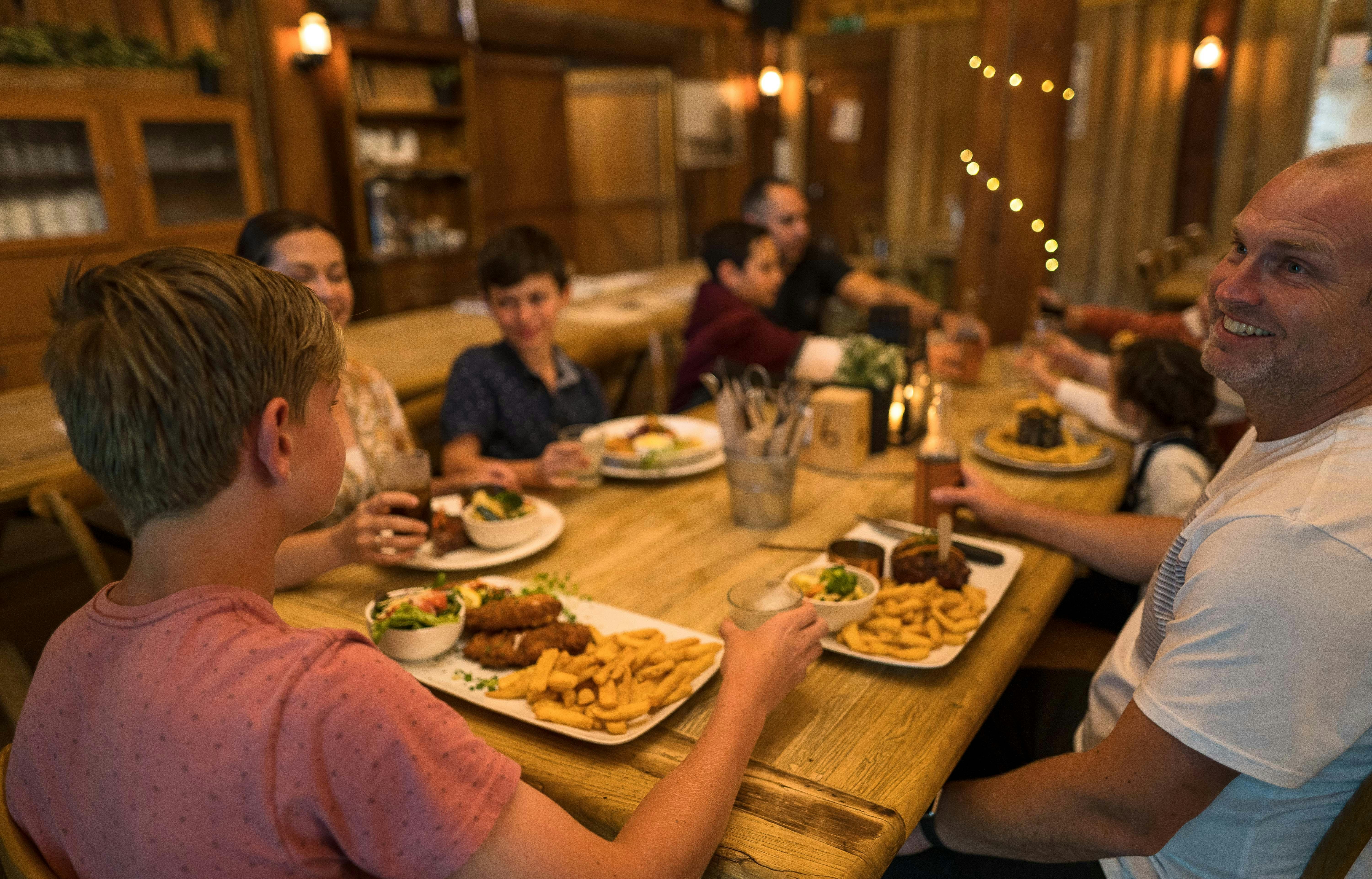Group of adults and children enjoying their meal