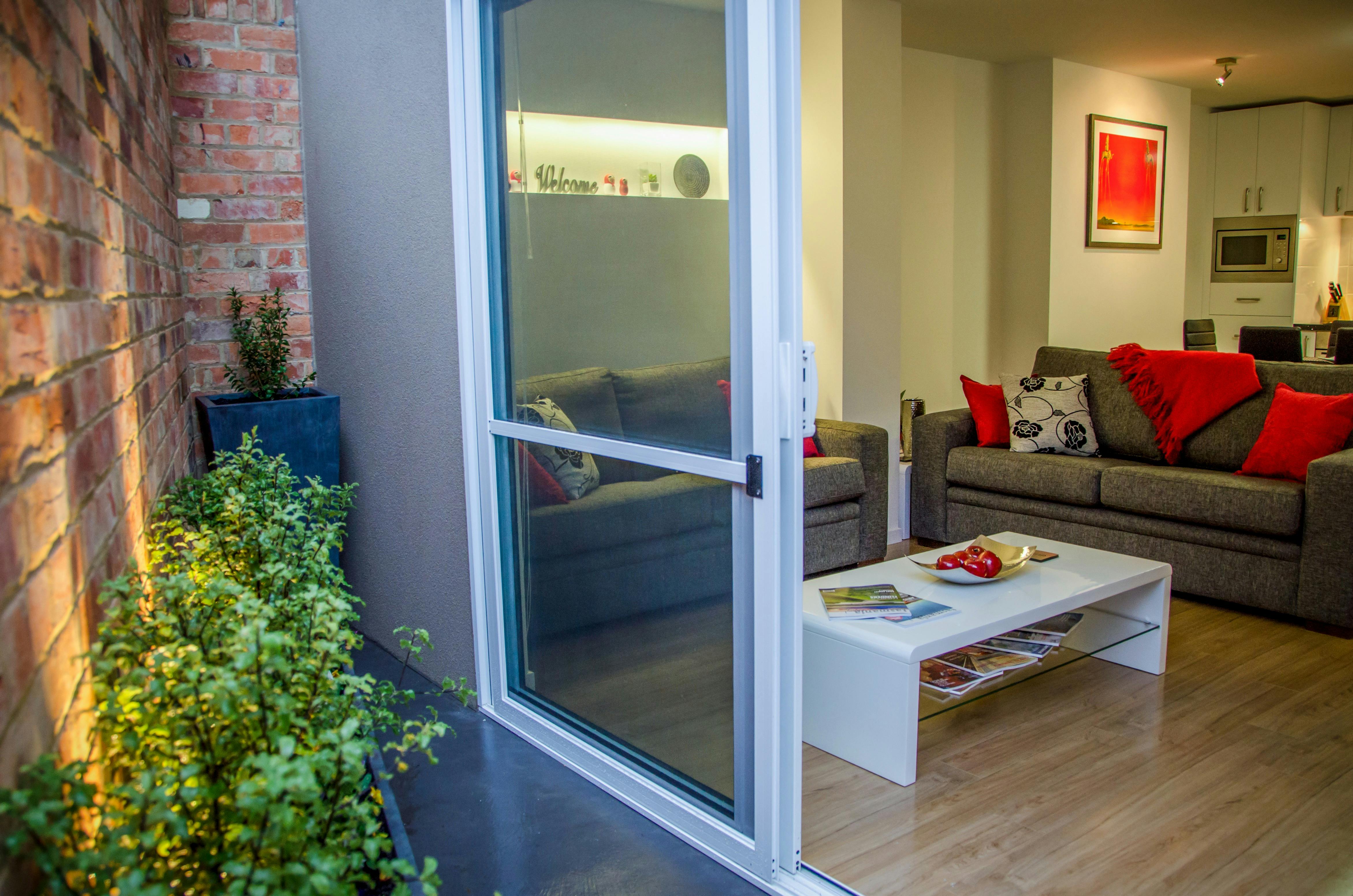 Private courtyard with outdoor seating accessed through sliding doors from the open-plan living area