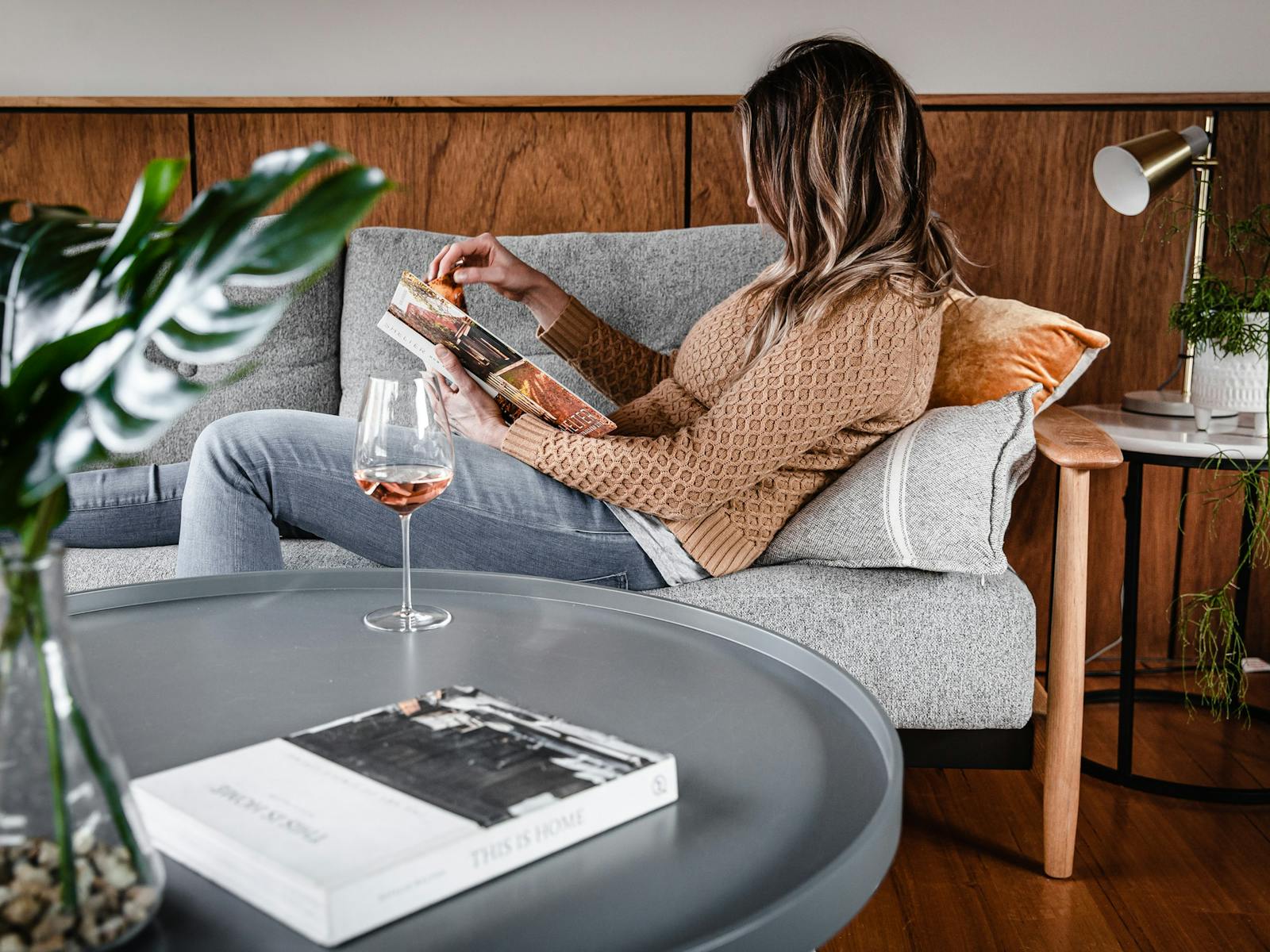 Lady relaxing on the sofa, which converts into a sofa bed.