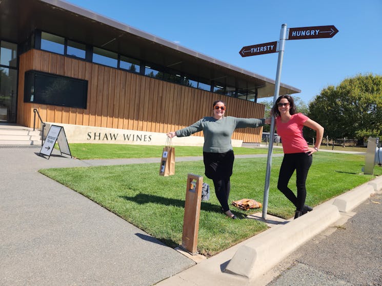 Photo of Canebrra winery tour EV with 2 females posing at Shaw Wines