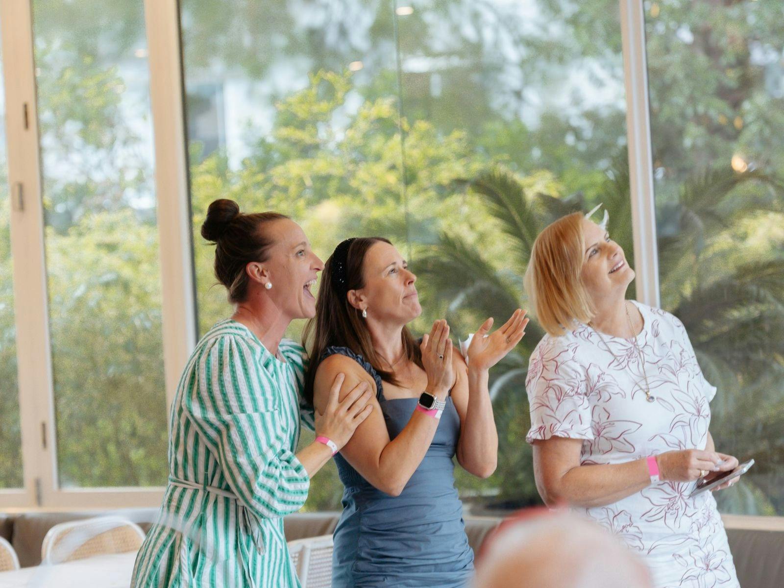Three women watching Melbourne Cup racing at Towradgi Beach Hotel.