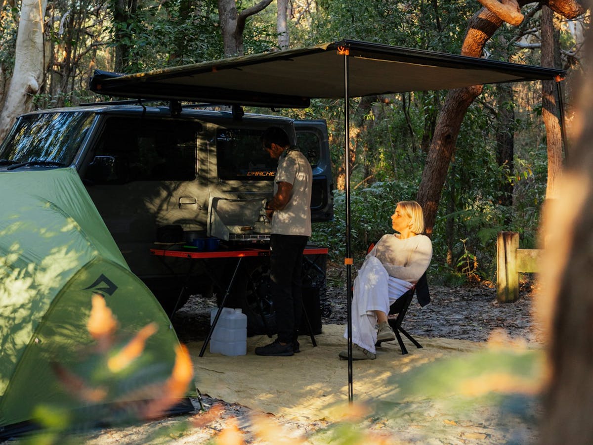 Campers relaxing as the sunset on their campsite