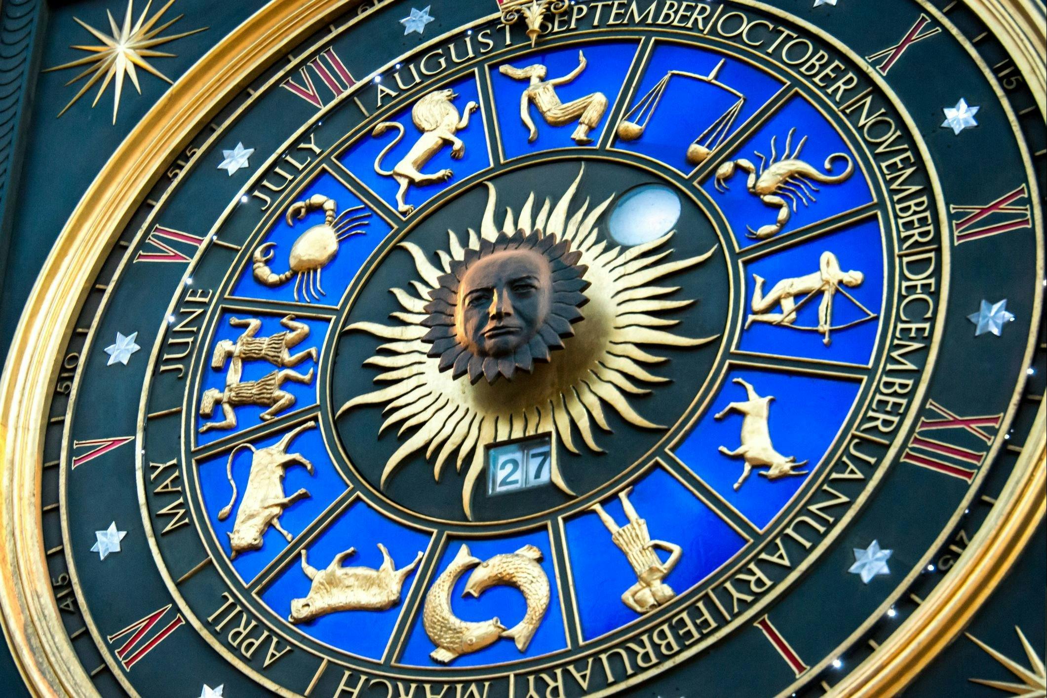 blue and goald clock with astro symbols