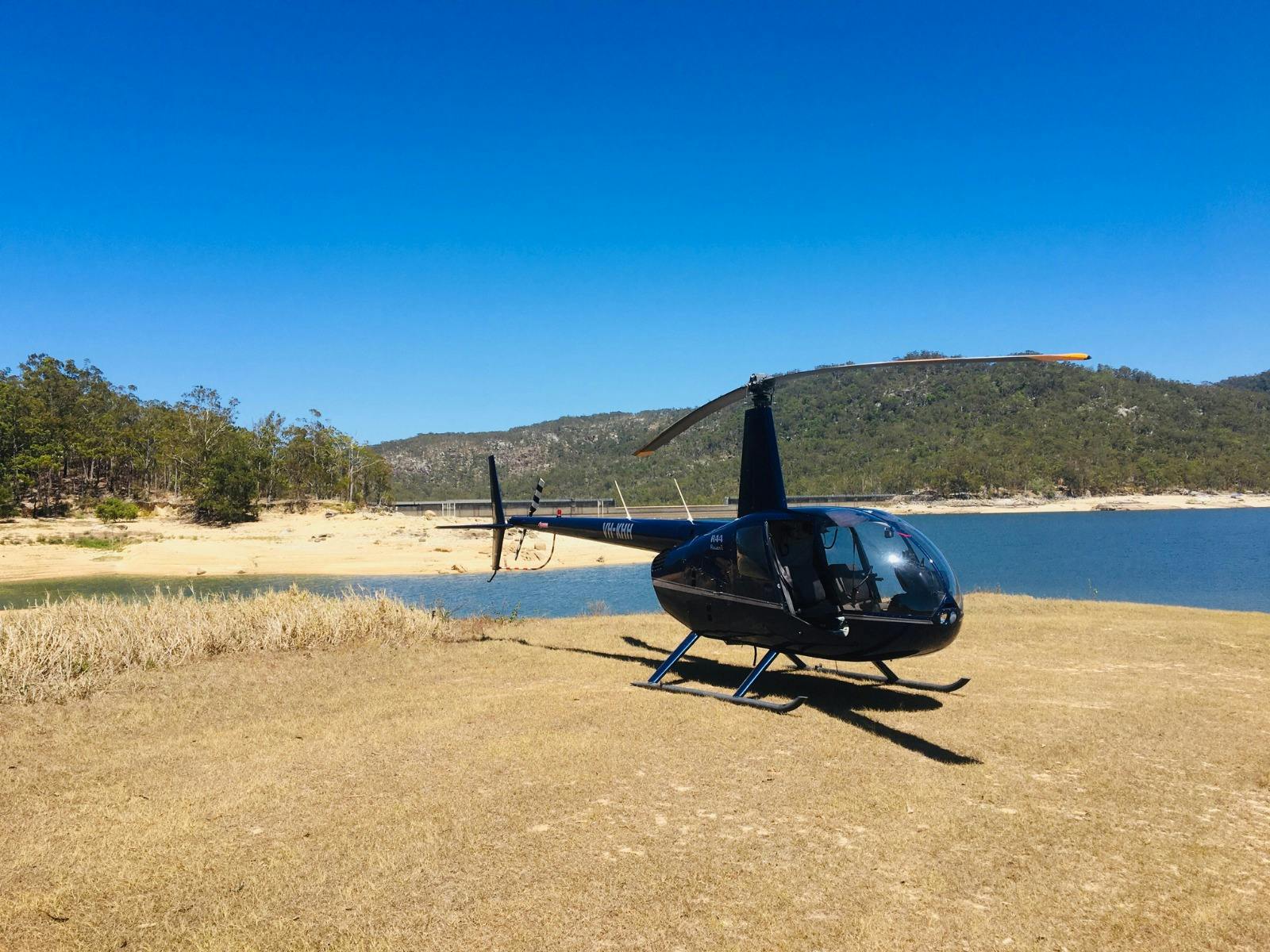 Robinson R44 Helicopter on the banks of Tinaroo Falls Dam