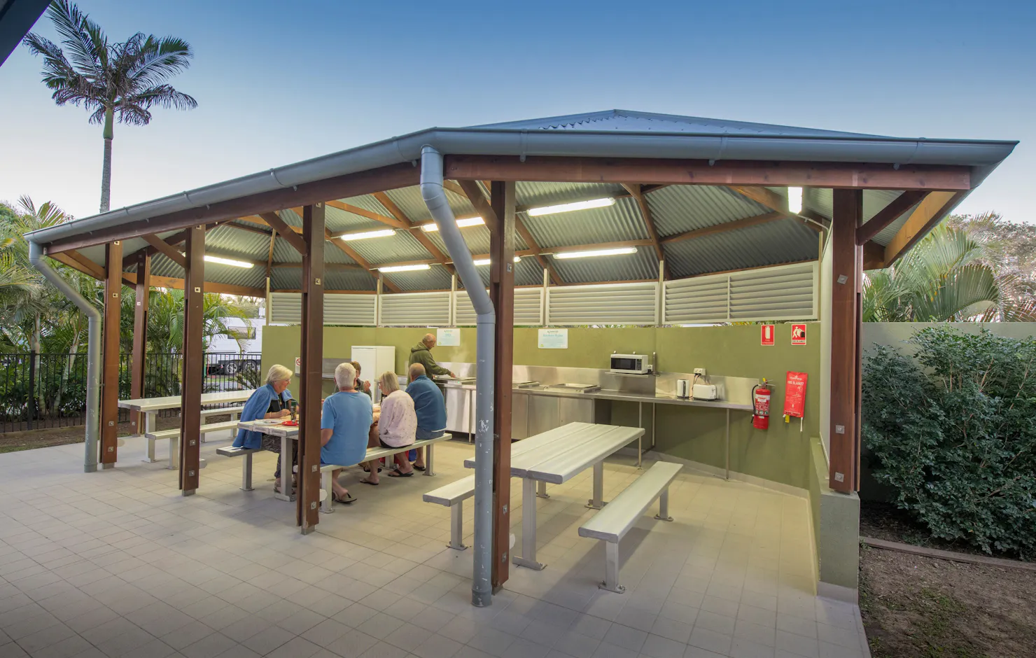 Cotton Tree Camp Kitchen wide shot with people sitting down and someone cooking