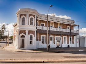 Exterior of the Pastoral Hotel Motel showing its historic facade and inviting entrance.