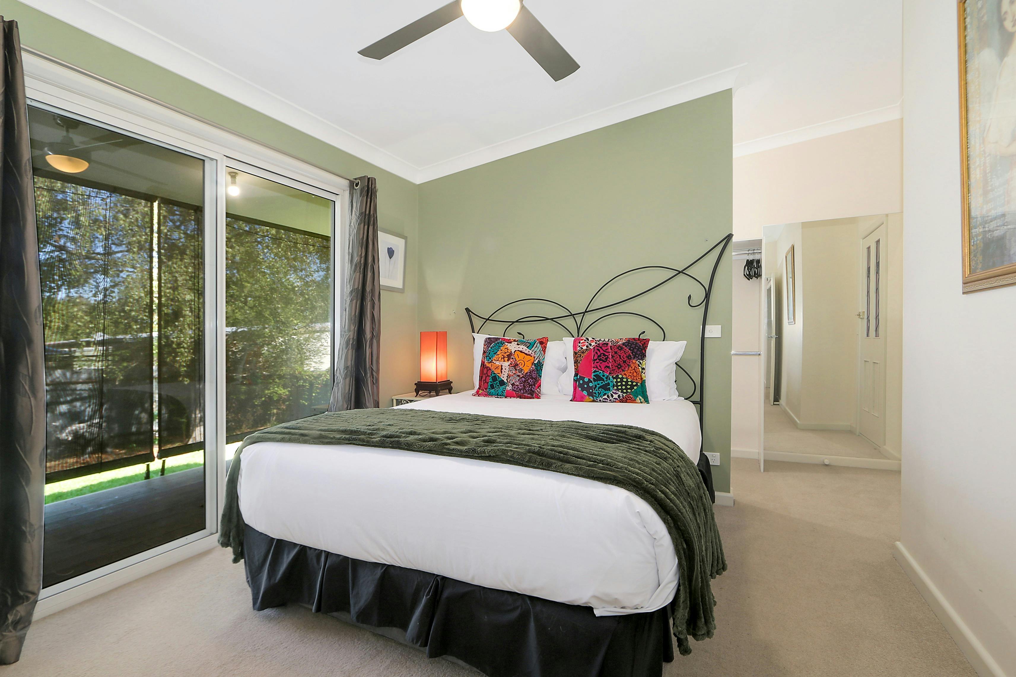 Main bedroom with comfortable bed and large window