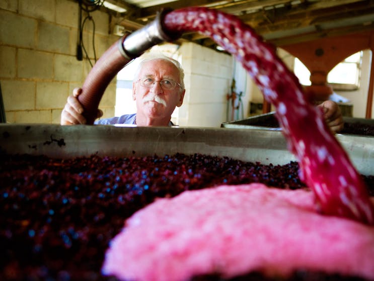 Wine maker Ken Helm at work with the vats