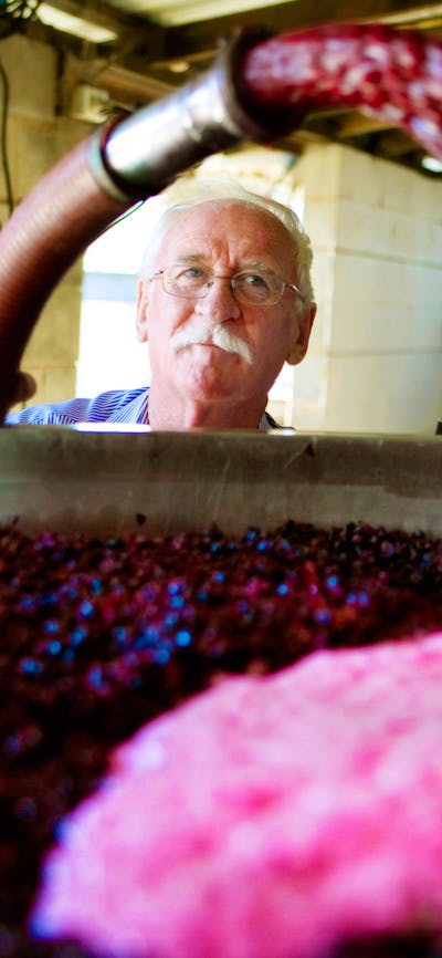 Wine maker Ken Helm at work with the vats