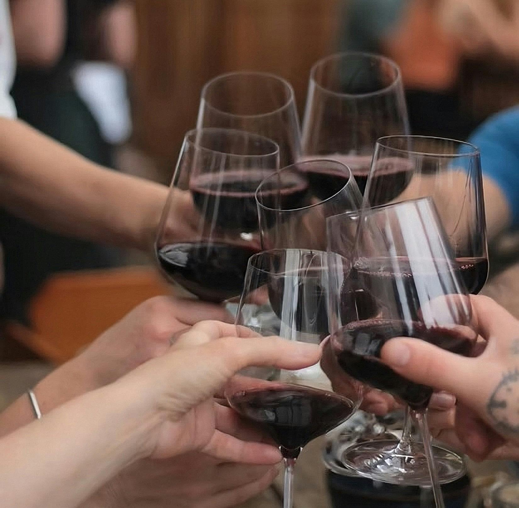 Wine glasses full of red wine