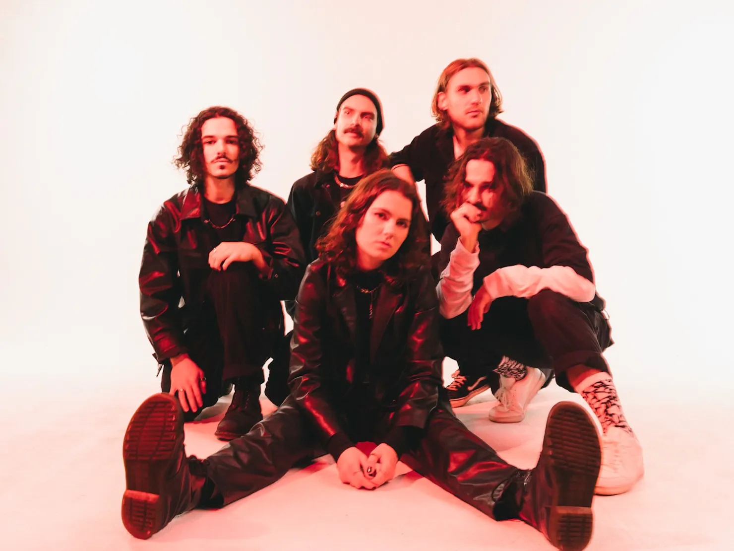 Band sitting together with a blurred photo angle