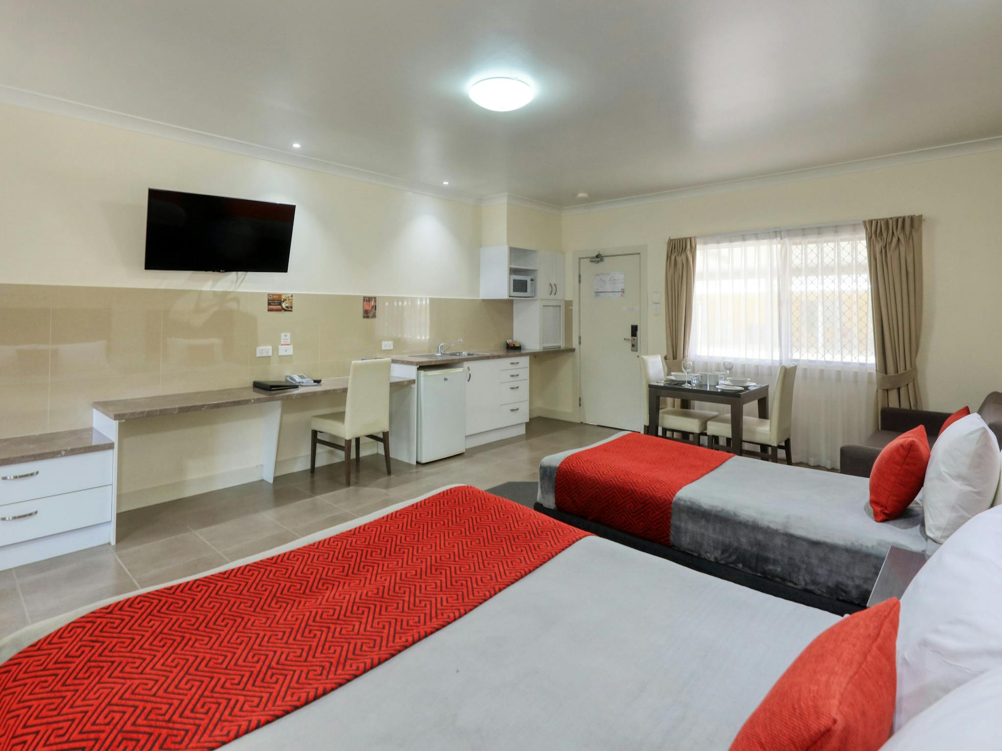queen and single bed with our kitchenette showing very spacious queen and single bed with our kitchenette showing very spacious