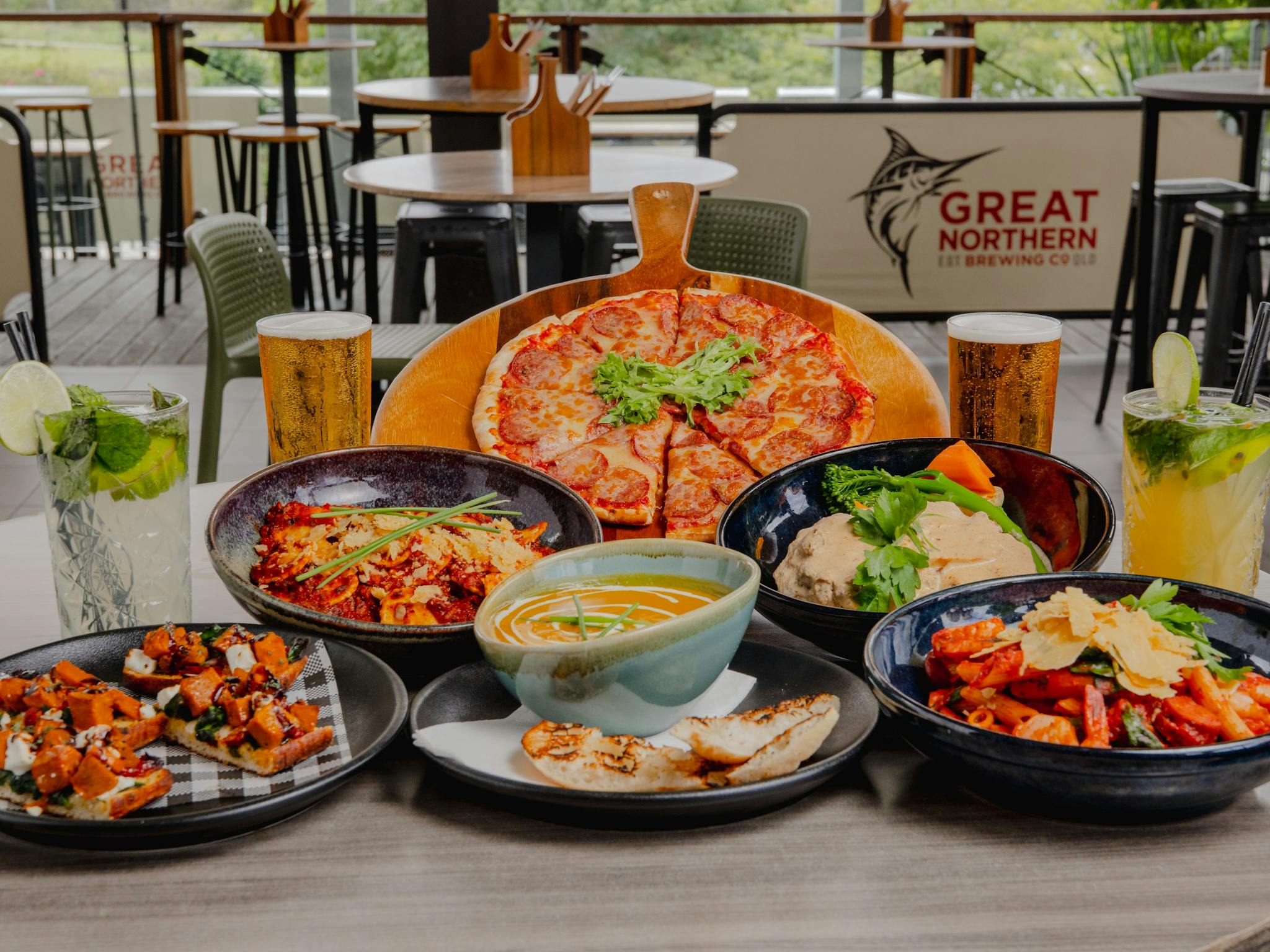 Pizza, pasta, soup, bruschetta, beer and cocktails on a table at Orion Hotel Springfield Pizza, pasta, soup, bruschetta, beer and cocktails on a table at Orion Hotel Springfield