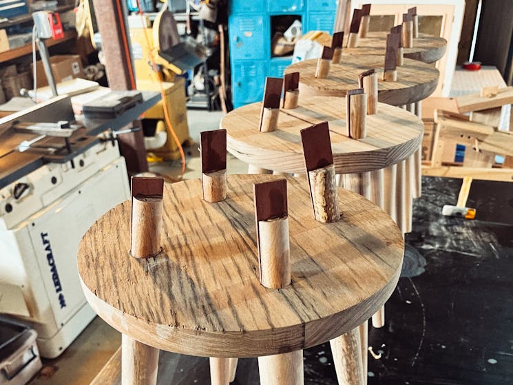 Four legged stools with wedges holding the legs in.