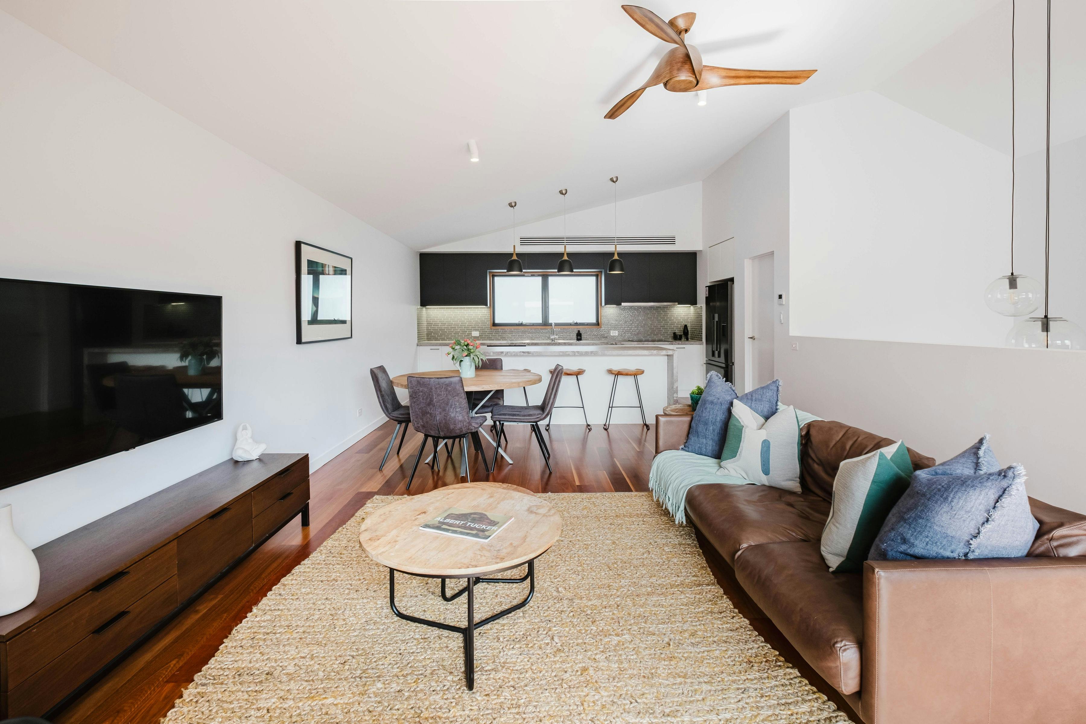 Hester arthouse townhouse living area with couch, television, tea table and dining table