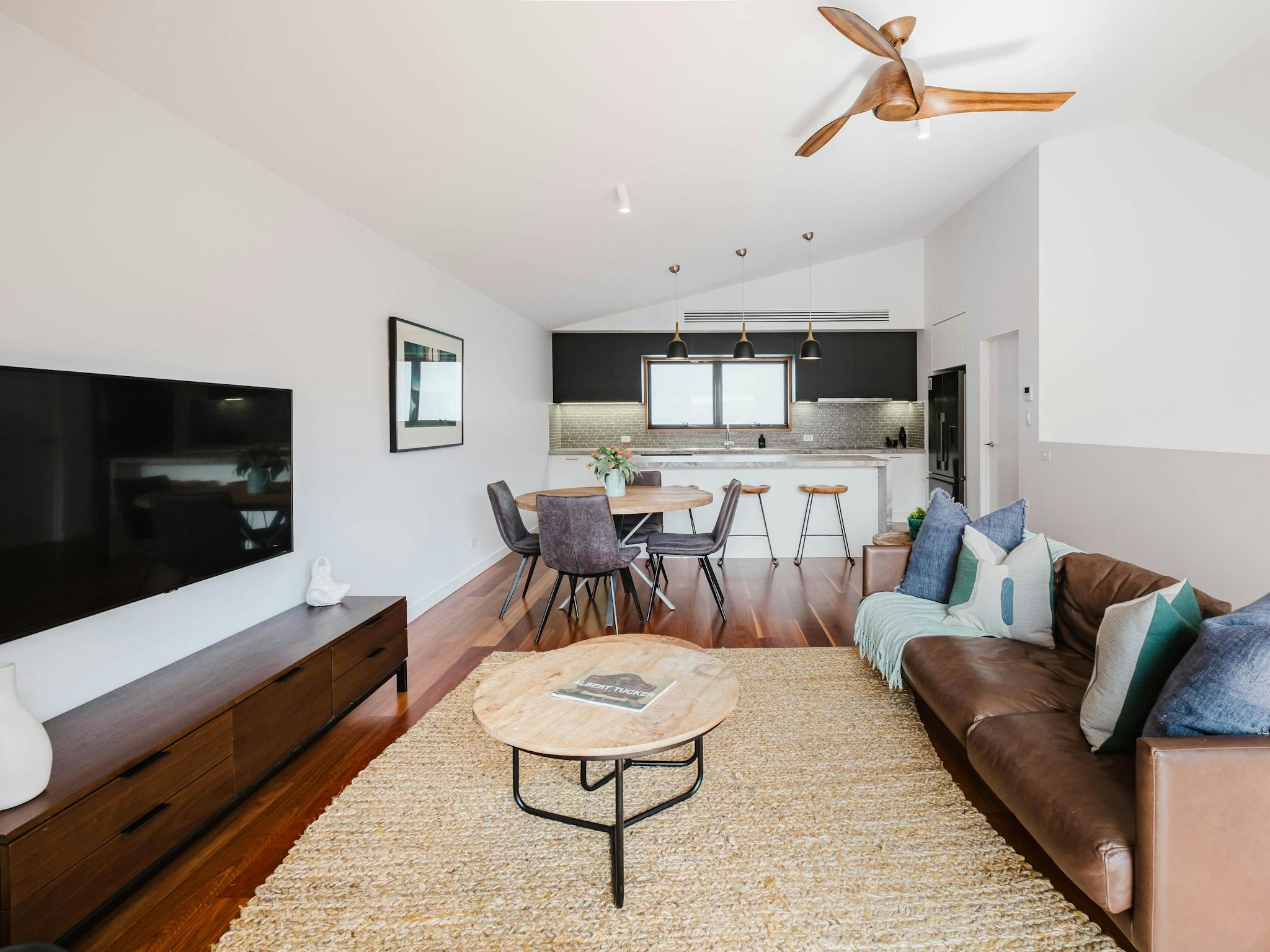 Hester arthouse townhouse living area with couch, television, tea table and dining table