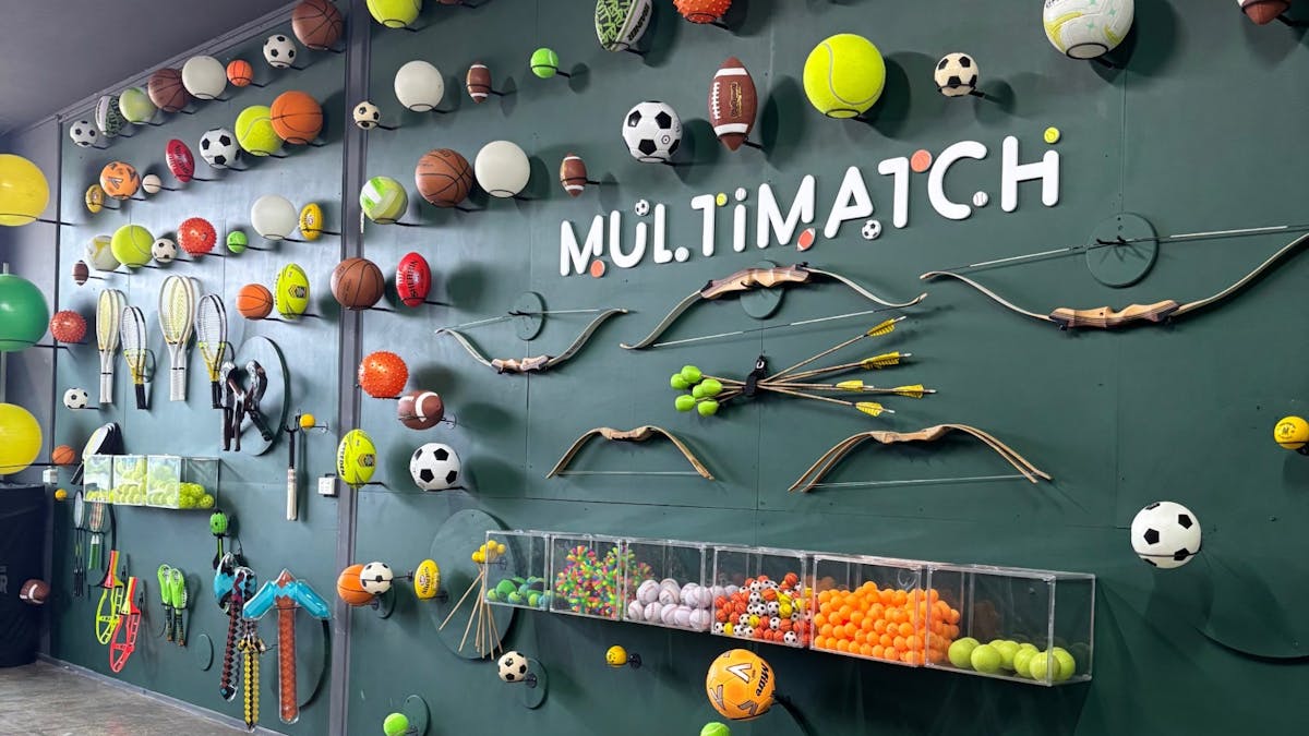 MultiMatch Cleveland equipment wall with sports balls and gear in the indoor studio.