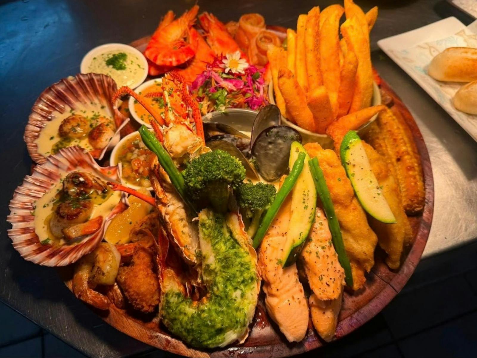Oceania Feast seafood platter with lobster, scallops, prawns, mussels, salmon, fish, chips and seaso