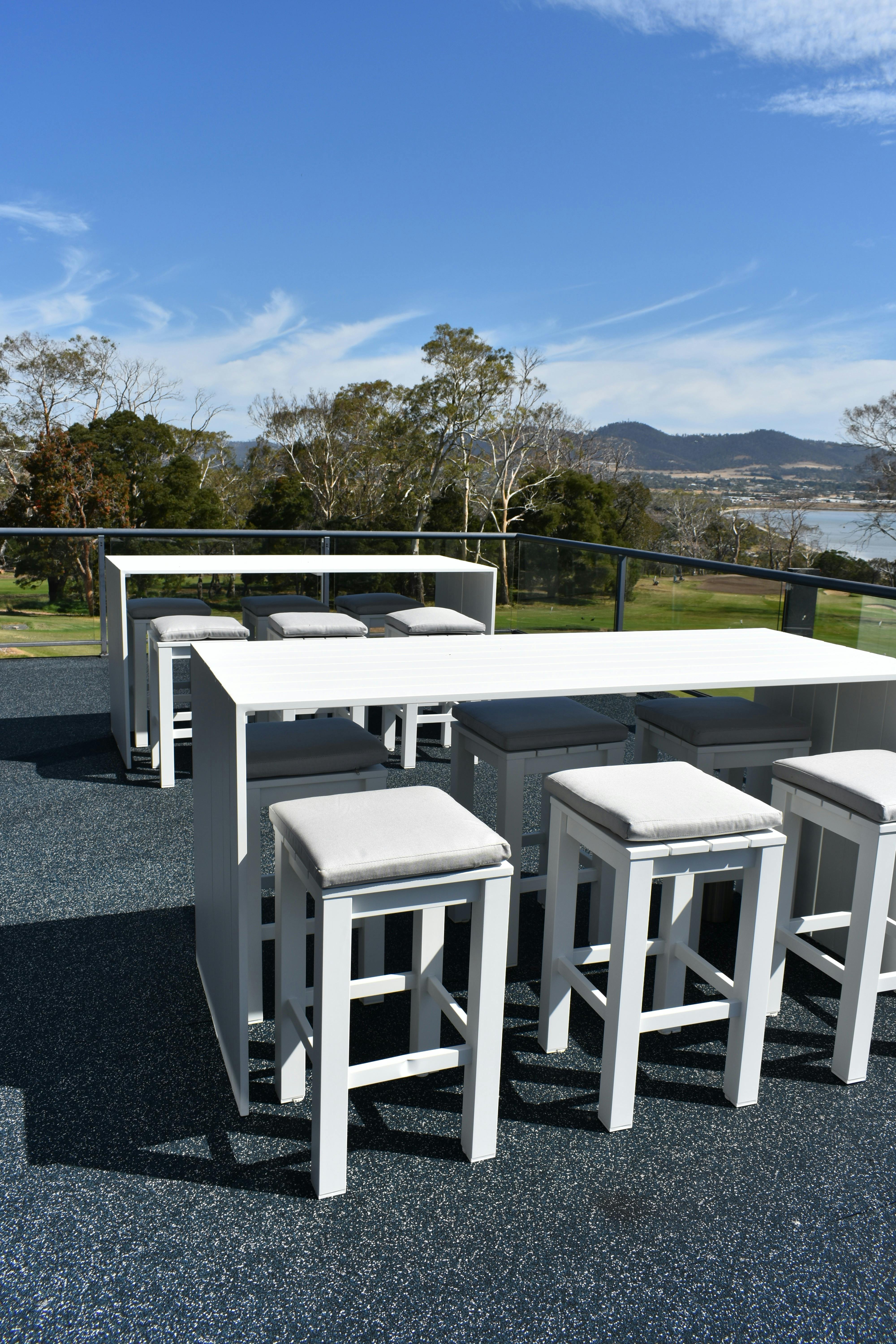 Tables and stools on the deck for extra seating.