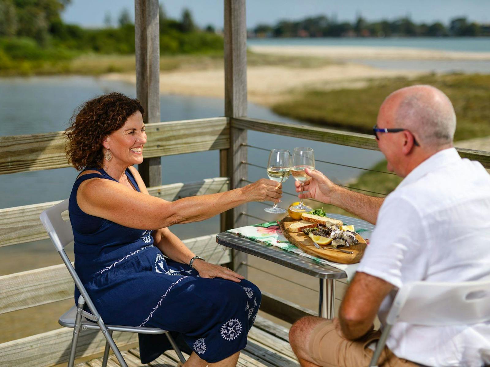 A woman and a man dining by the river at Richmond Oysters