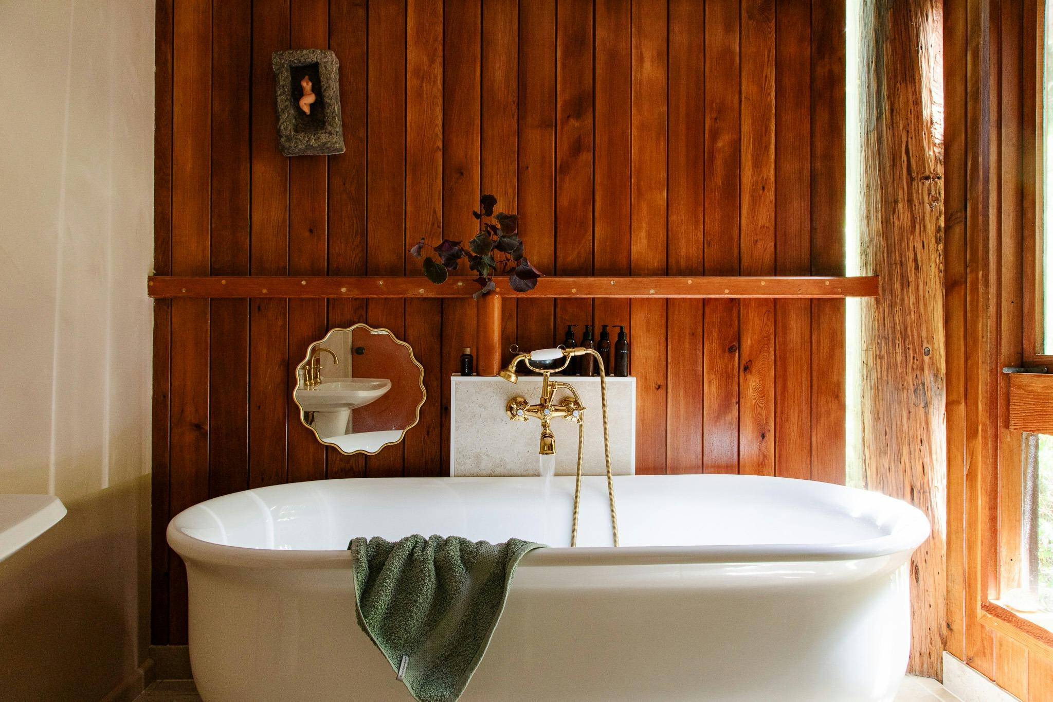 An oversize bathtub with vintage tapware