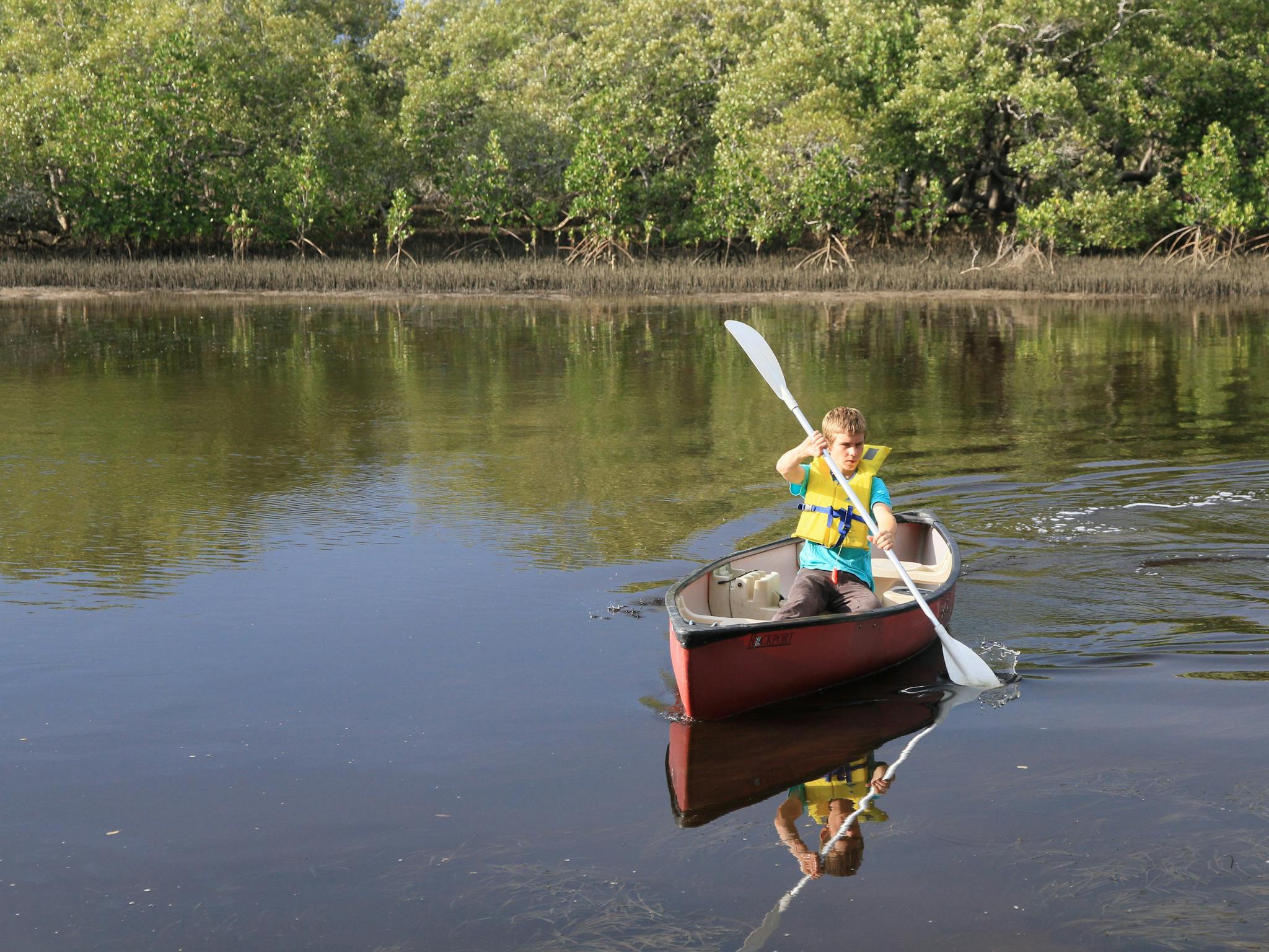 Person canoeing on river