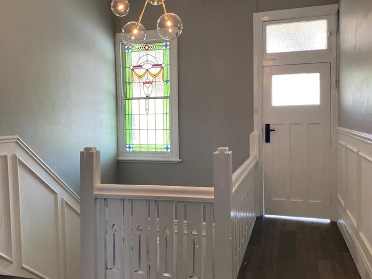 Hallway with light, newly painted, stairs going down