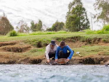 A couple panning for gold in the creek