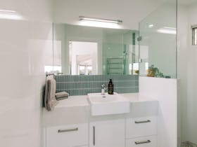 The upstairs bathroom contains a shower and a vanity - toilet is separate