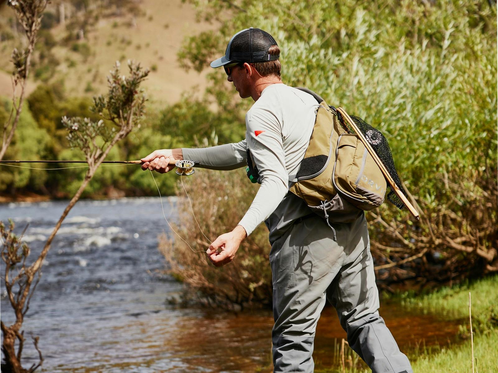 Guiding customer practicing casting on Tasmanian river