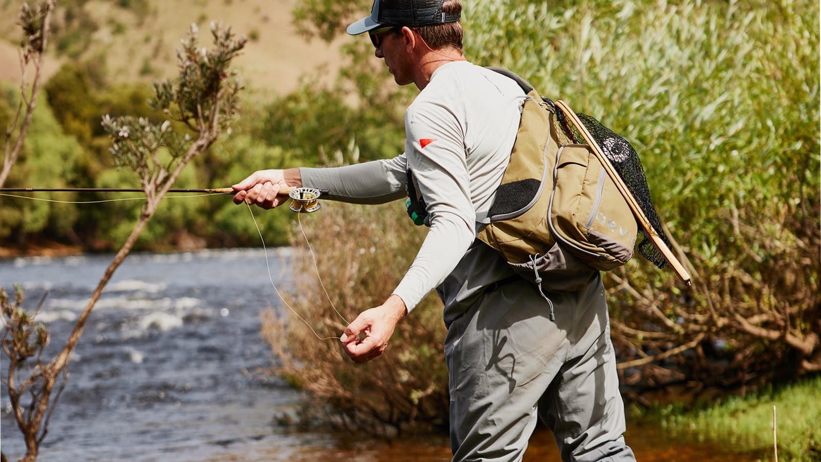 Guiding customer practicing casting on Tasmanian river