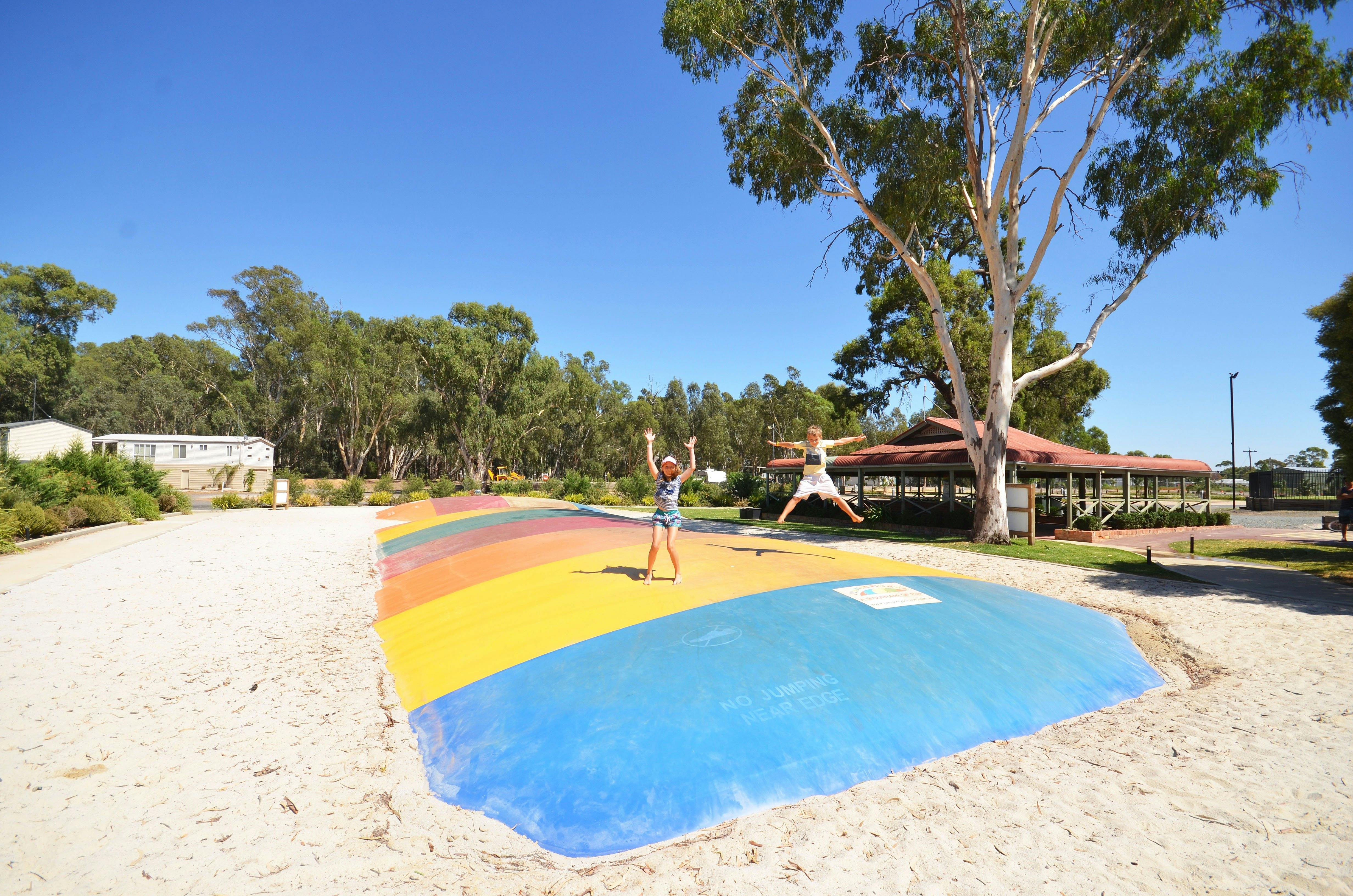 Kids jumping on giant jumping pillow