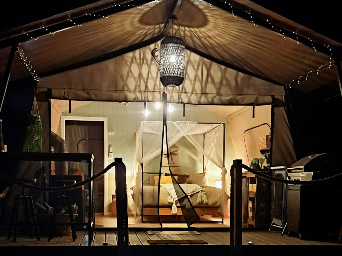 a luxury safari tent lit up at night a luxury safari tent lit up at night