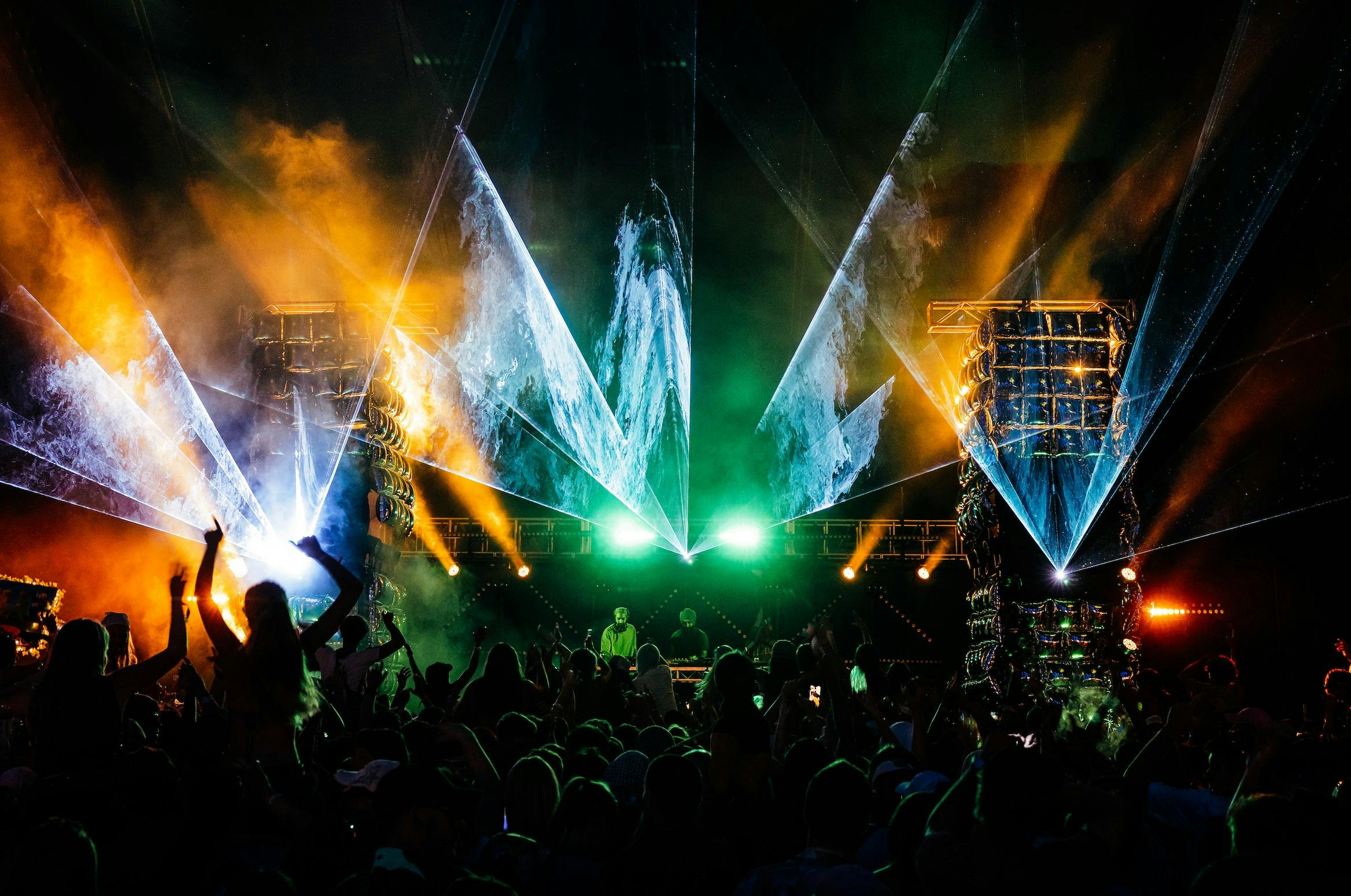 stage with crowd and lazer beam lighting