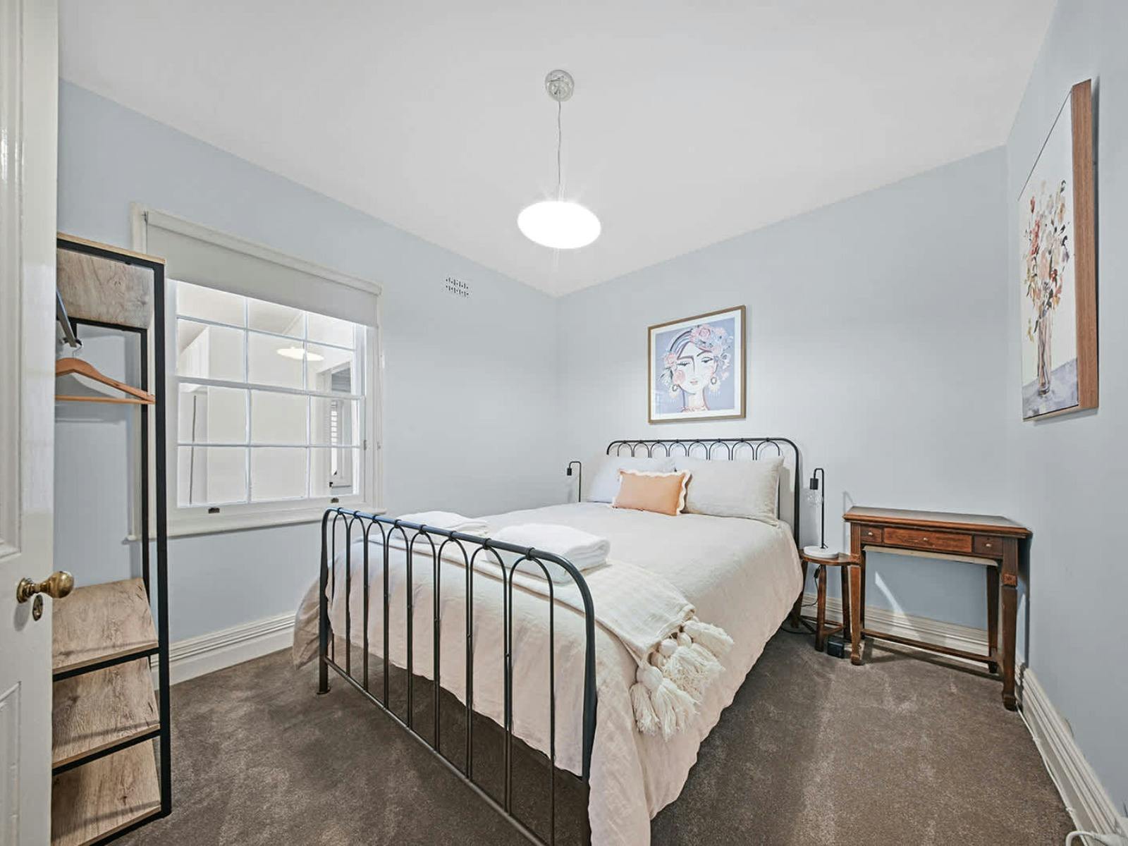 Metal bed with hanging and shelf space