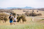 Friends walking in open landscape with scenic panoramic views of the region