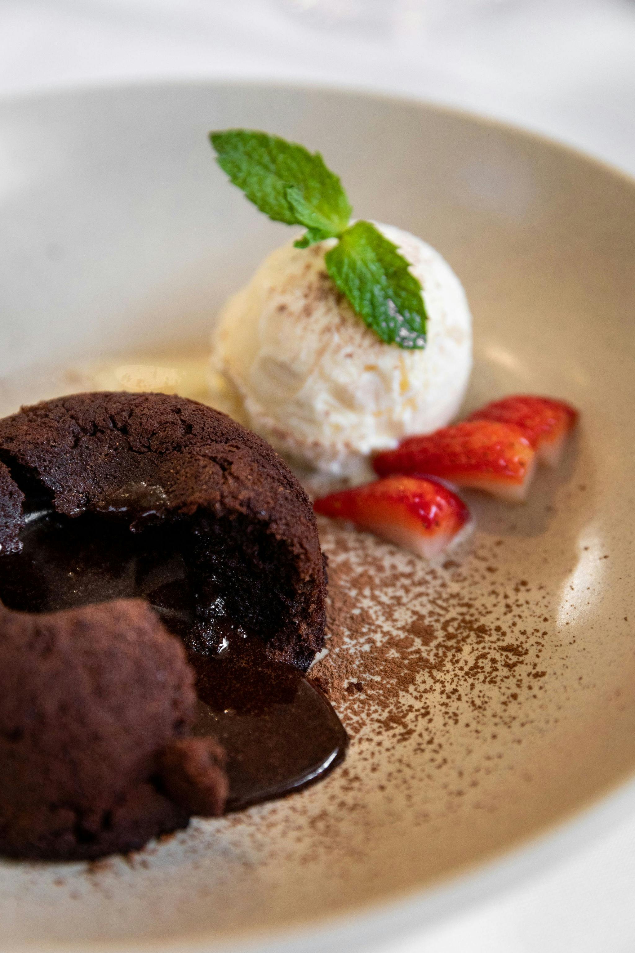 Decadent house made chocolate cake with an oozing chocolate centre served with cream