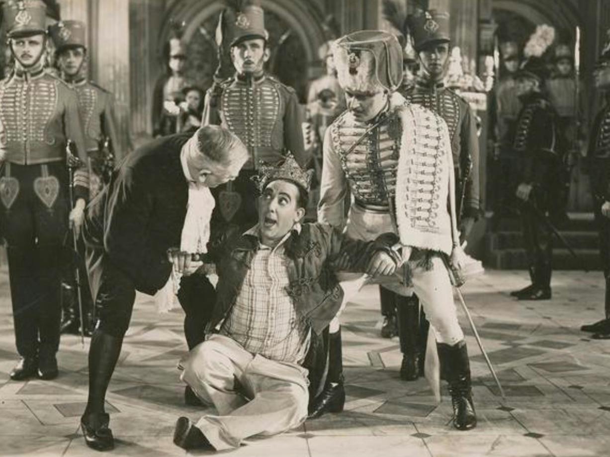 Black and white image of men dressed as royals