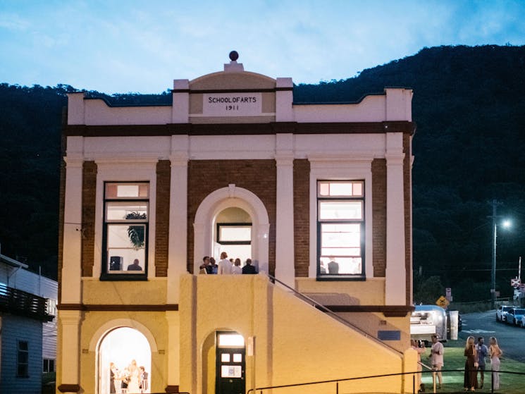 A victorian building at dusk.