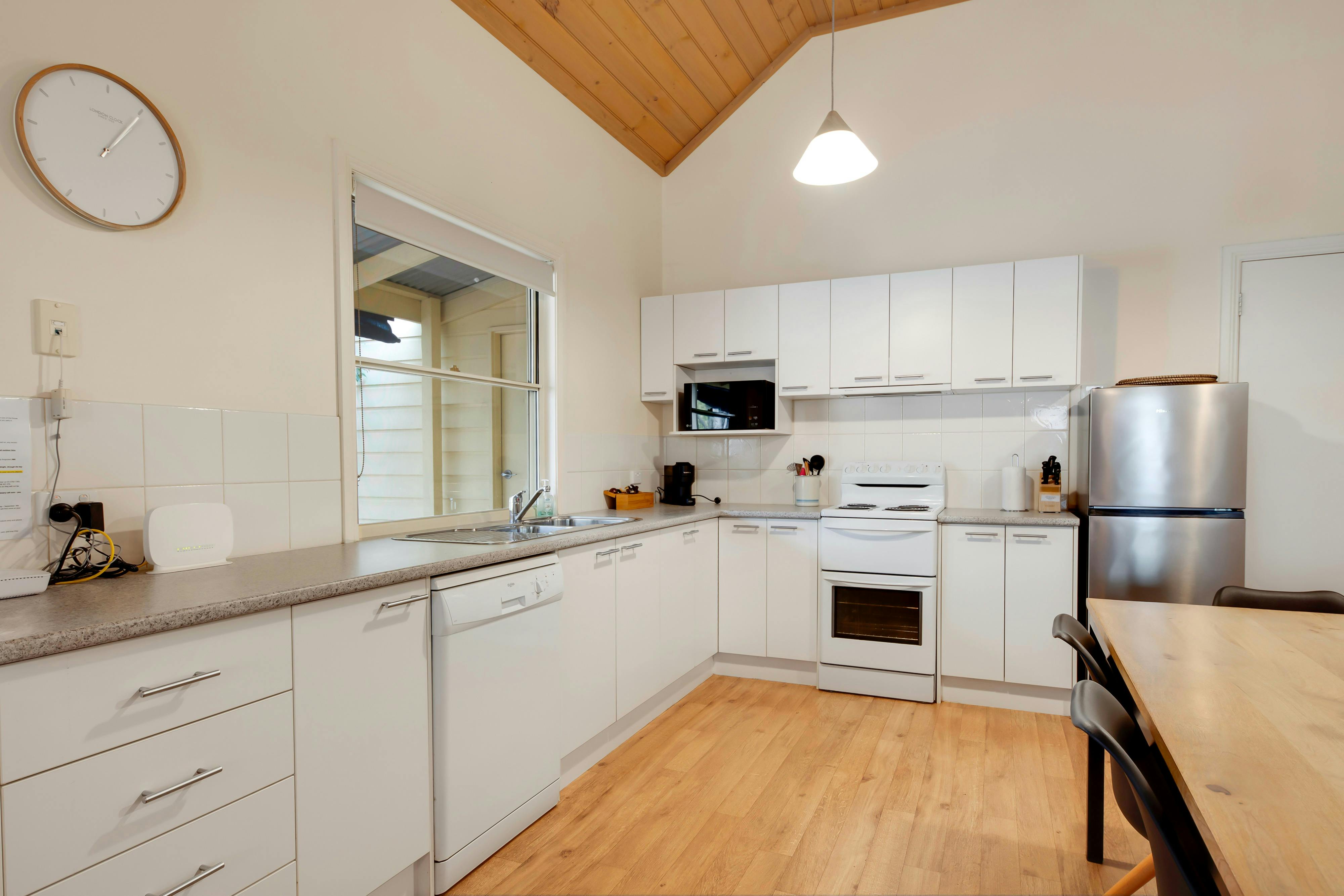 Kitchen with oven, stovetop, fridge, microwave and dishwasher