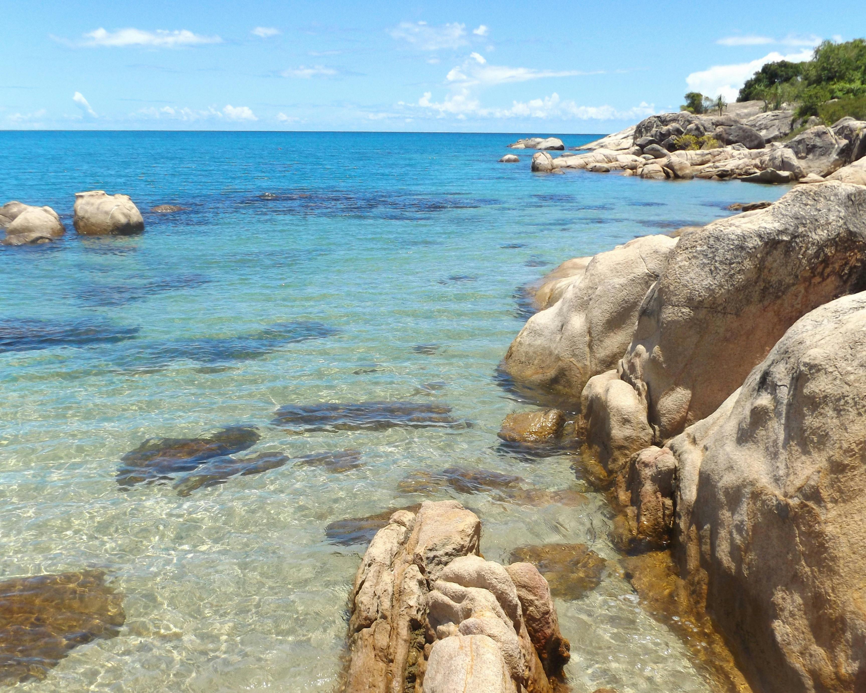 Granite rocks, clear blue water in sheltered bay