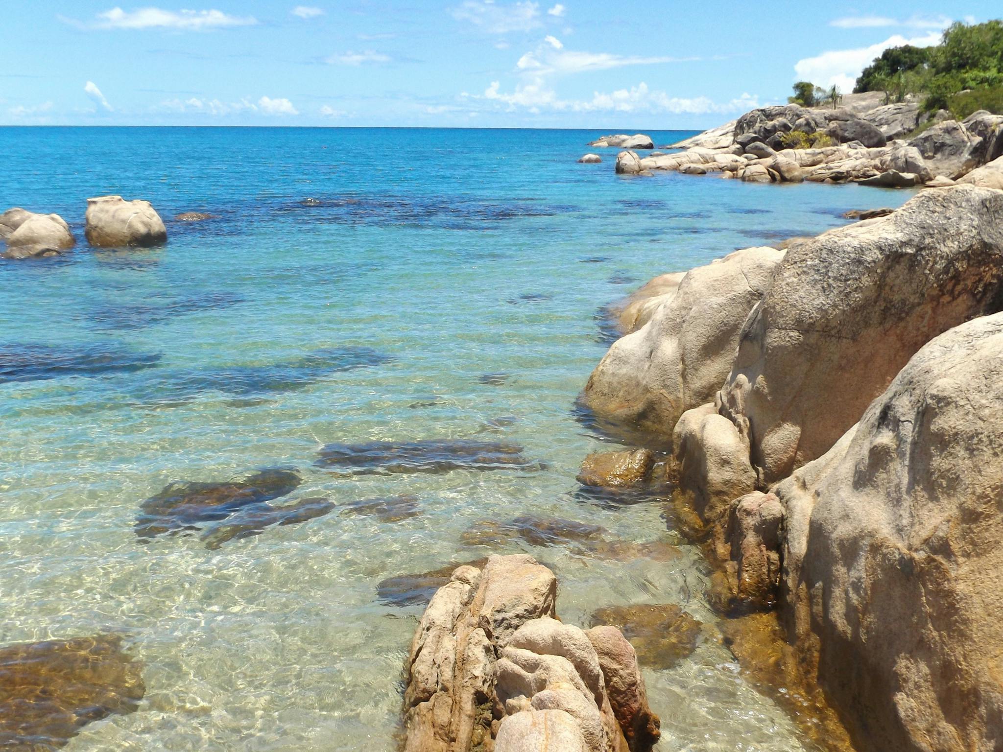 Granite rocks, clear blue water in sheltered bay